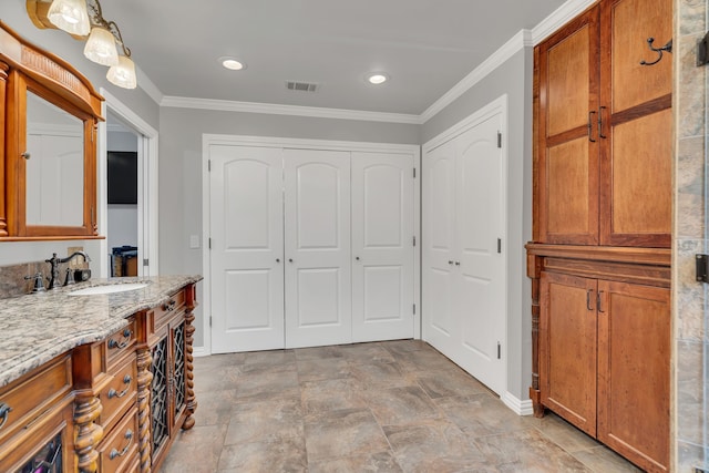 bathroom featuring vanity and ornamental molding