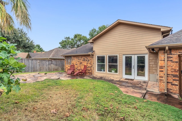 rear view of house featuring a yard, french doors, and a patio area