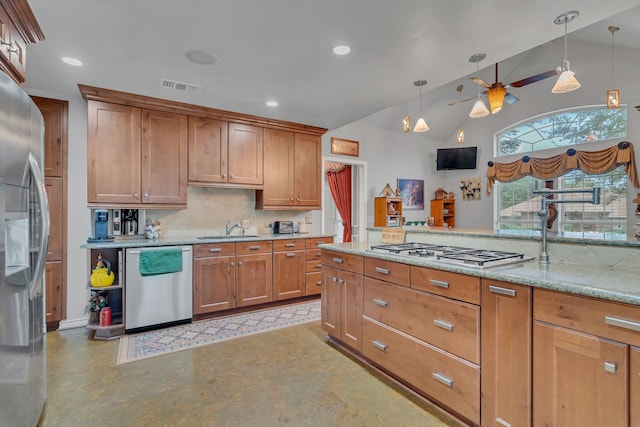 kitchen with decorative light fixtures, stainless steel appliances, visible vents, brown cabinetry, and a sink