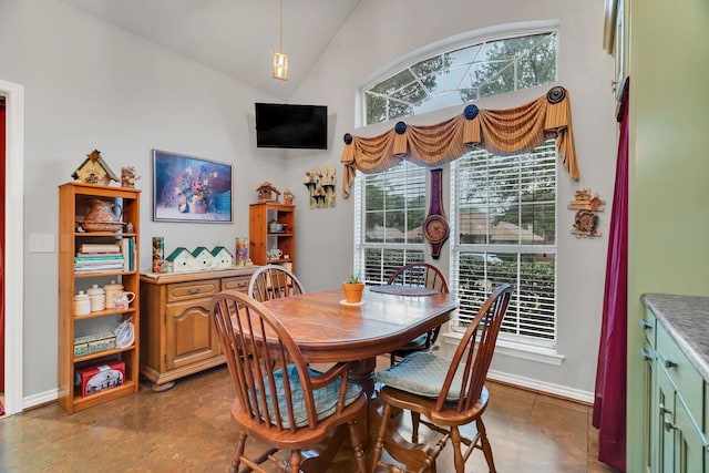 dining room with a healthy amount of sunlight and lofted ceiling