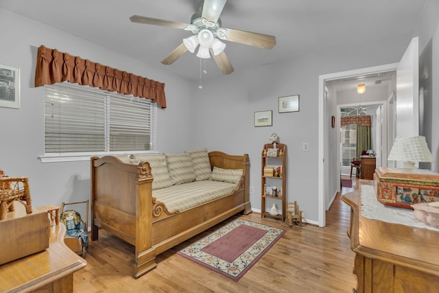 living room with light hardwood / wood-style flooring and ceiling fan