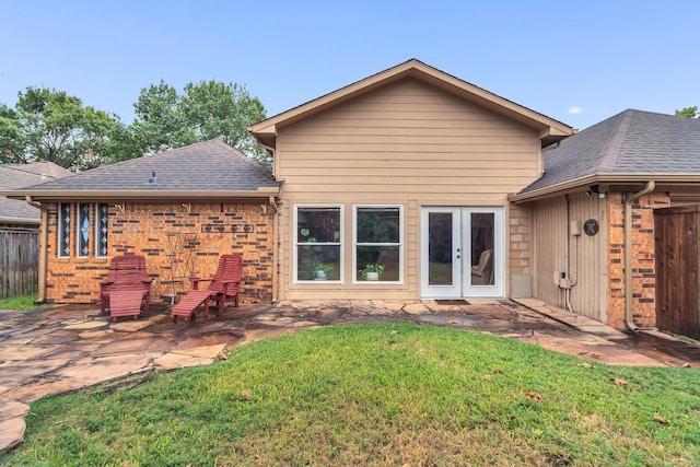 back of property featuring a yard, french doors, and a patio area