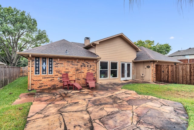 rear view of property featuring a patio and a yard