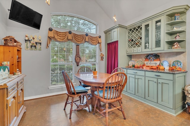 dining space with concrete flooring and lofted ceiling