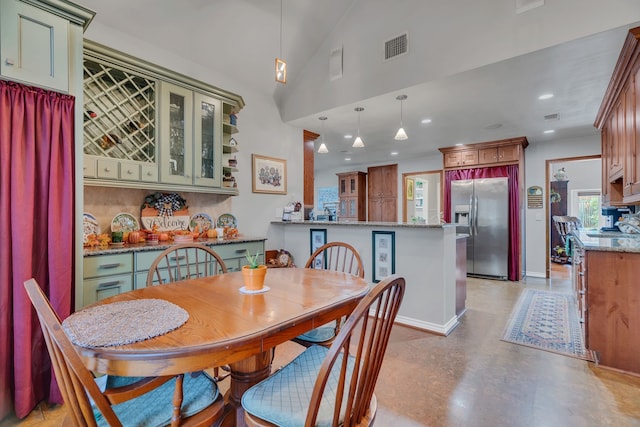 dining area featuring vaulted ceiling