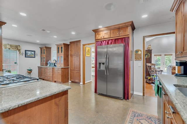 kitchen featuring french doors, light stone counters, and stainless steel appliances