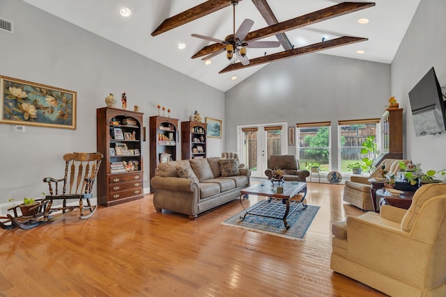 living room with ceiling fan, beam ceiling, light hardwood / wood-style flooring, and high vaulted ceiling