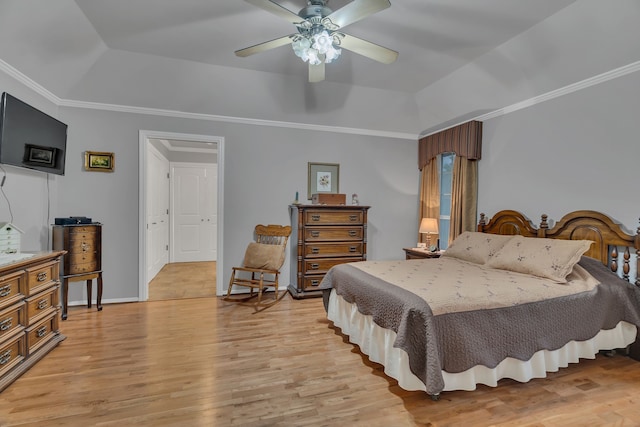 bedroom with ornamental molding, light hardwood / wood-style floors, ceiling fan, and a raised ceiling