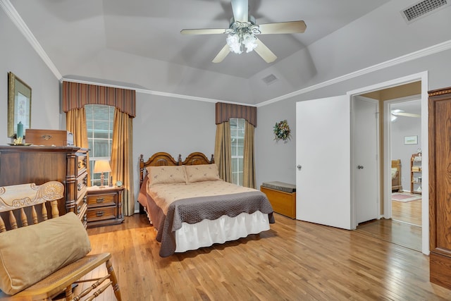 bedroom with ceiling fan, crown molding, light wood-type flooring, and lofted ceiling