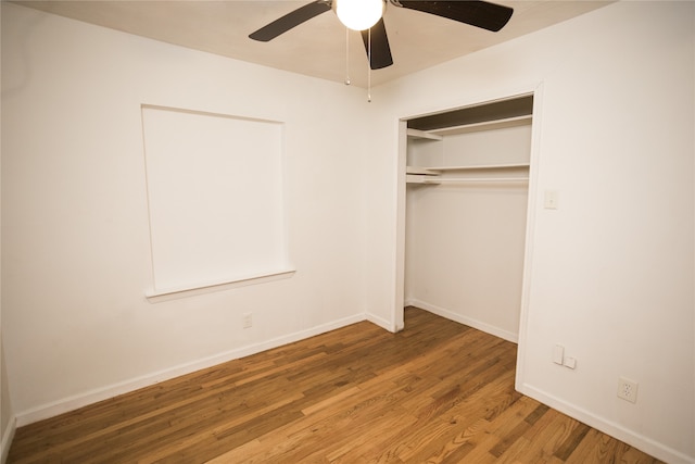 unfurnished bedroom with a closet, wood-type flooring, and ceiling fan