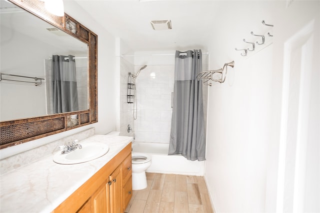 full bathroom with hardwood / wood-style floors, vanity, shower / bathtub combination with curtain, and toilet