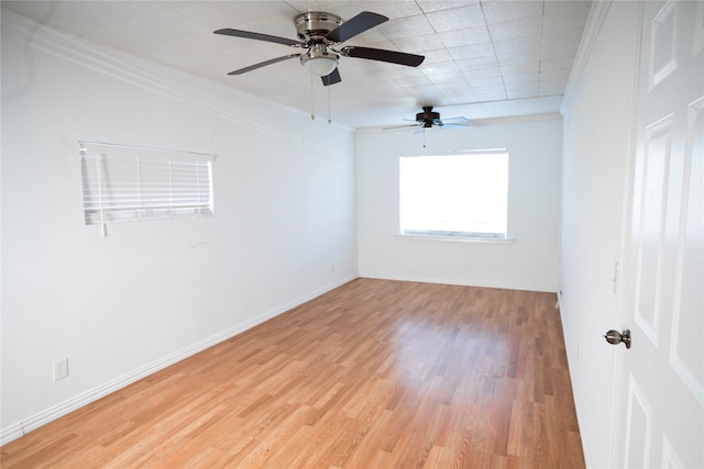 unfurnished room with light hardwood / wood-style floors, ceiling fan, and ornamental molding