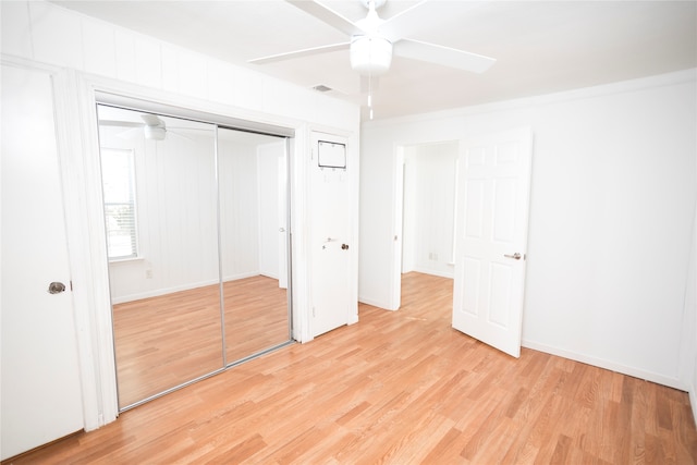 unfurnished bedroom with a closet, light wood-type flooring, and ceiling fan