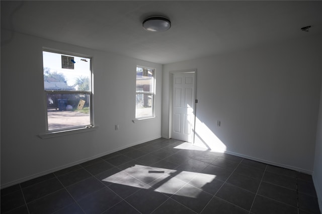 tiled empty room with a wealth of natural light