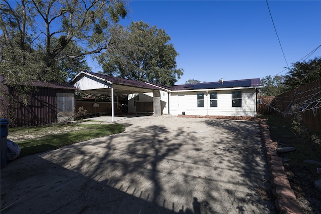 rear view of house featuring a shed