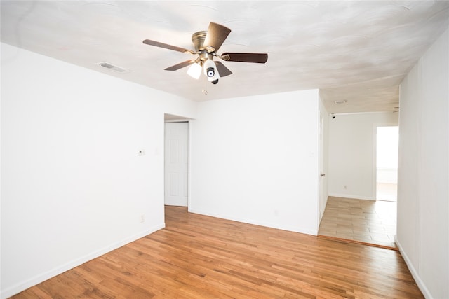 spare room featuring light hardwood / wood-style floors and ceiling fan