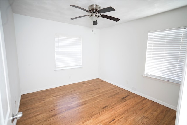 unfurnished room with ceiling fan and wood-type flooring