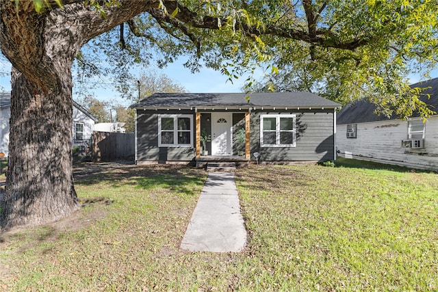 view of front of home featuring cooling unit and a front lawn