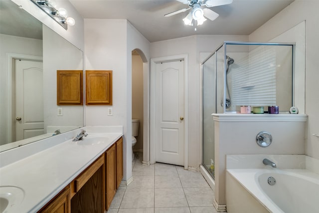 full bathroom with tile patterned flooring, ceiling fan, vanity, shower with separate bathtub, and toilet