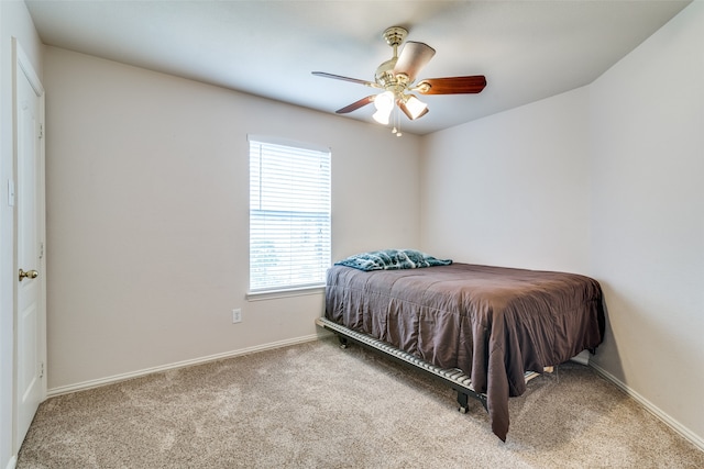 bedroom with light carpet and ceiling fan