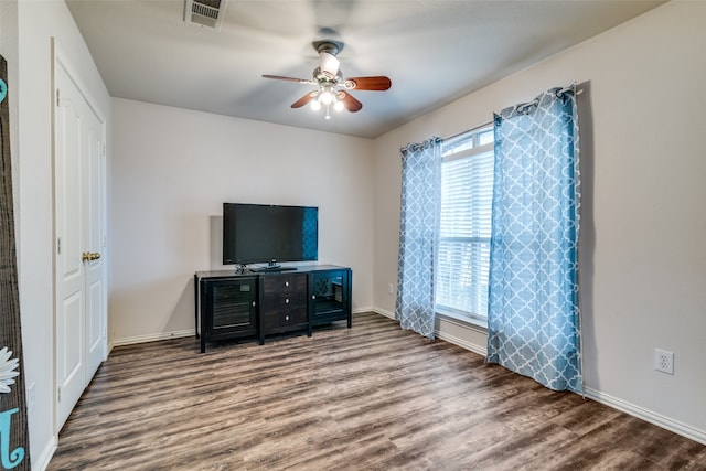 living room featuring hardwood / wood-style floors and ceiling fan