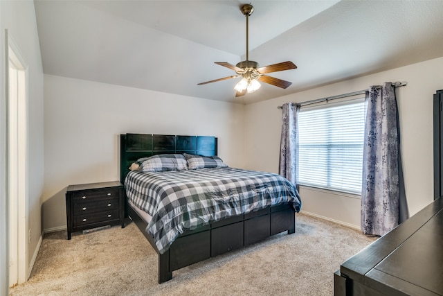 carpeted bedroom featuring lofted ceiling and ceiling fan