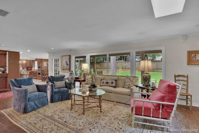 living room featuring a notable chandelier and ornamental molding