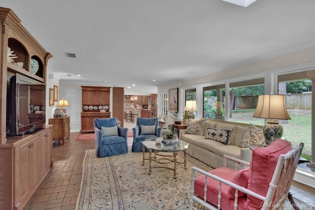 living room with plenty of natural light and crown molding