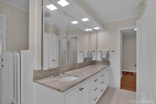 bathroom with vanity, hardwood / wood-style flooring, and crown molding