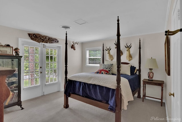 carpeted bedroom with access to exterior, multiple windows, and crown molding