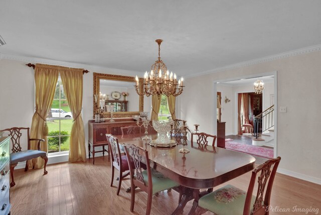 dining space featuring light hardwood / wood-style floors and crown molding