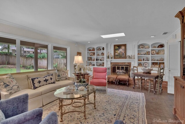 living room with built in features, a skylight, and crown molding