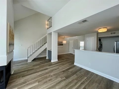 unfurnished living room featuring dark wood-type flooring