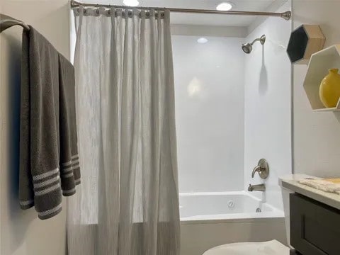 bathroom featuring vanity and shower / tub combo