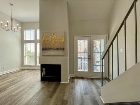 doorway to outside featuring french doors, a wealth of natural light, and hardwood / wood-style flooring