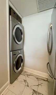 laundry room featuring stacked washing maching and dryer