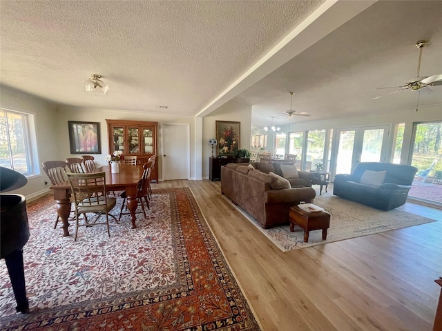 dining space featuring a textured ceiling, light hardwood / wood-style flooring, and ceiling fan