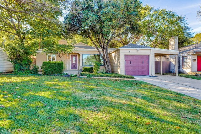 ranch-style house featuring a garage, a carport, and a front yard