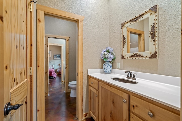 bathroom featuring toilet and vanity