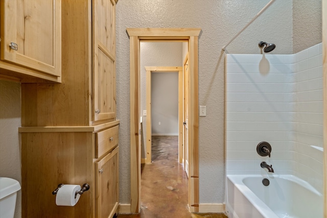 bathroom featuring toilet and  shower combination