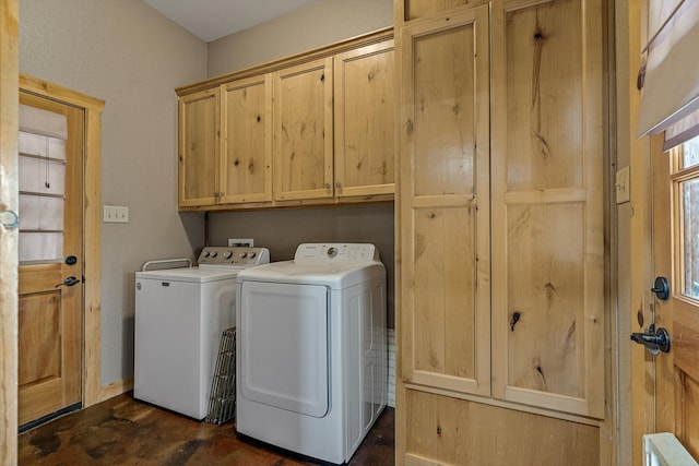 clothes washing area with cabinets and independent washer and dryer