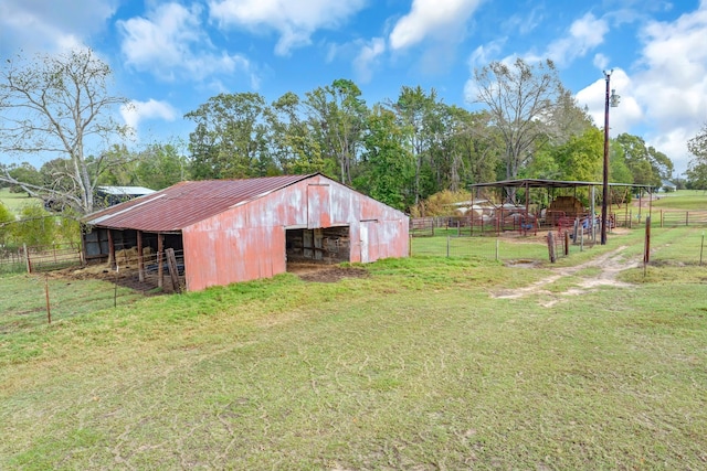 view of yard with an outbuilding and a rural view