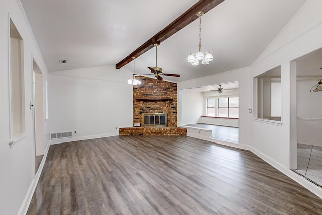 unfurnished living room with a brick fireplace, ceiling fan with notable chandelier, lofted ceiling with beams, and dark hardwood / wood-style floors