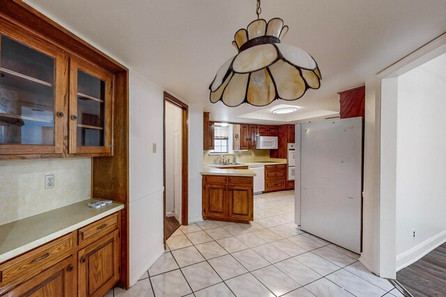 kitchen featuring sink, white appliances, and light tile patterned floors