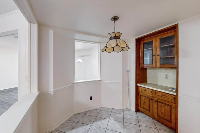 unfurnished dining area featuring light tile patterned floors