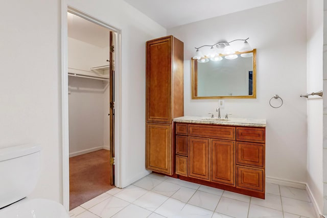 bathroom with tile patterned floors, vanity, and toilet