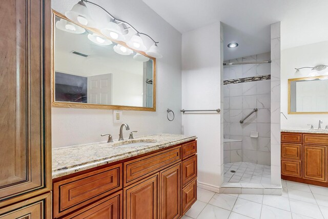 bathroom with vanity, tile patterned floors, and tiled shower