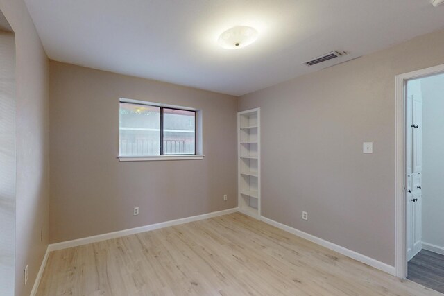 spare room with light wood-type flooring