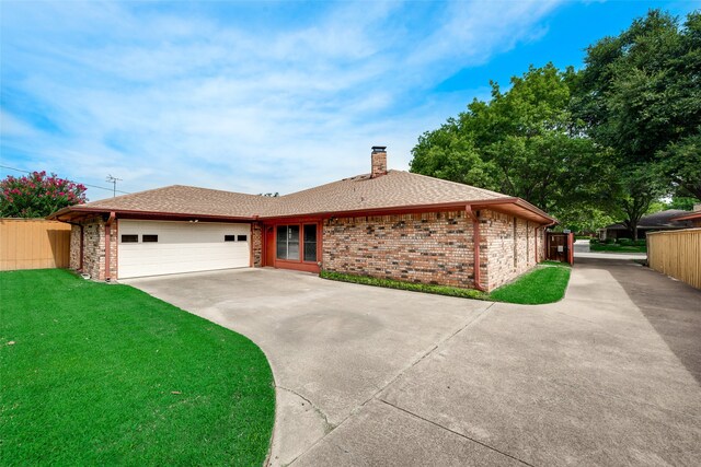 ranch-style house with a garage and a front lawn