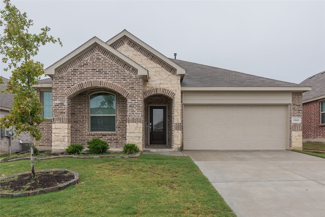 view of front of property with a garage and a front yard